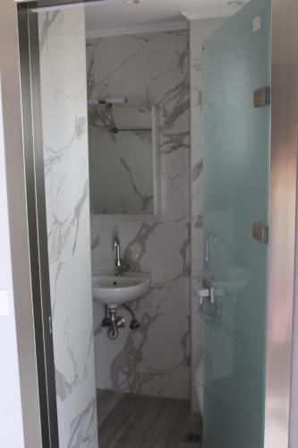 a bathroom with a sink and a mirror at BEST PARADISE IN NIKITI in Nikiti