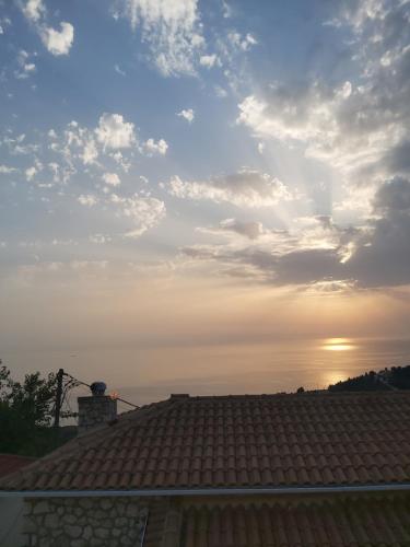 a view of the sunset from the roof of a house at Ionian Avra Apartment in Athanion