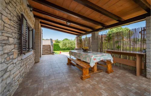 a patio with a table and a bench at Six-Bedroom Holiday Home In Barban in Barban