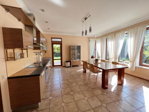 a large kitchen with a table and a dining room at Vaivari Retreat in Jūrmala