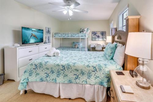 a bedroom with a bed and a ceiling fan at Sea Shell 24 in Clearwater Beach