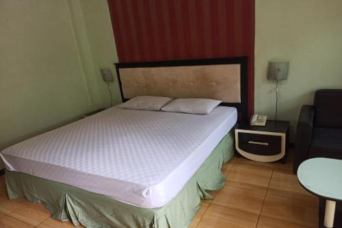 En eller flere senge i et værelse på OYO 92762 Wisma Pundu Syariah