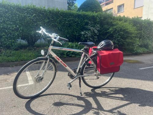 a bike parked in a parking lot with a helmet on it at DnN - Stylish Studio, 2 peoples- WiFi, Netflix, parking - min away to Basel and Airport - dishwasher, washing machine in Saint-Louis