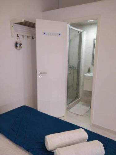 a bathroom with a blue bed and a shower at JB House in Nazaré