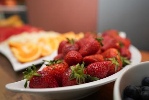 a bowl of strawberries and blueberries on a table at Hotel Attaché an der Messe in Frankfurt/Main