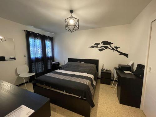 1 dormitorio con 1 cama, 1 mesa y 1 silla en appartement cosy à 100m de la plage, CLIM, WIFI, piscine, en Le Lavandou