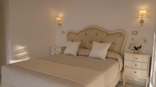 a bedroom with a large bed with two night stands at La Vigna del Vento in Casola di Napoli