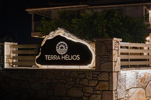 a sign for the terra helix hotel on a wall at Terra Hélios Suites & Studios in Kyparissia