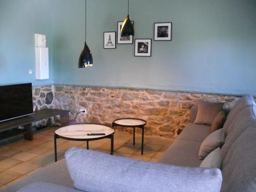 a living room with a couch and two tables at U Granu di Bellezza in Casta