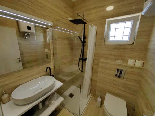 a bathroom with a shower and a toilet and a sink at Zvončica Deluxe in Vodice