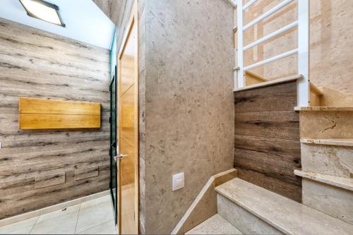 a walk in shower with a wooden wall at Casa Costa Esmeralda-shared pool in Costa Teguise