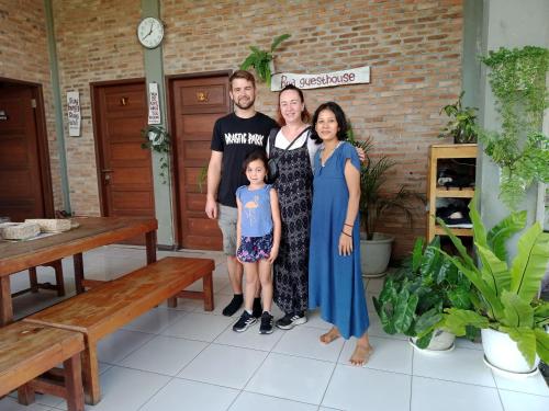 a family posing for a picture in a room at Bua Guest House in Medan