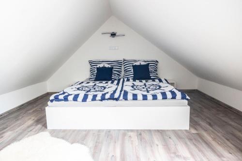 a bedroom with a bed in a attic at ŠUMAVSKÝ DVŮR in Sušice
