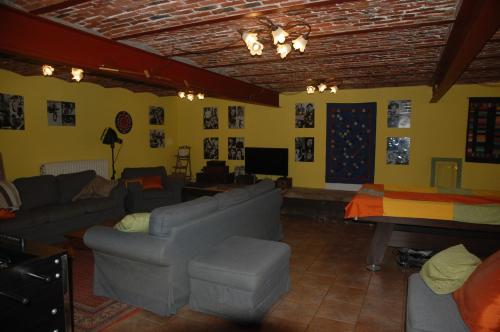 a living room with a couch and a table at Le Buisson B&B in Gouvy