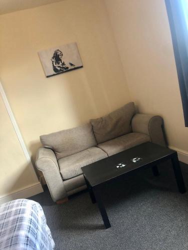 a living room with a couch and a coffee table at The Old Station House in Retford