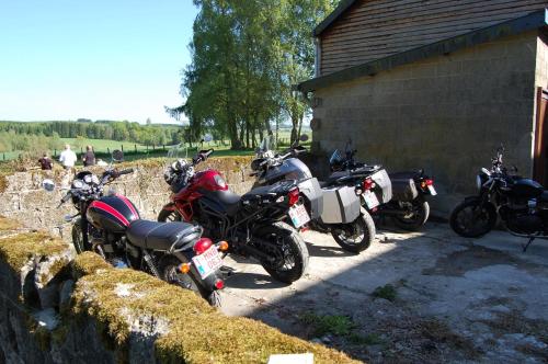 a group of motorcycles parked next to a building at Le Buisson B&B in Gouvy