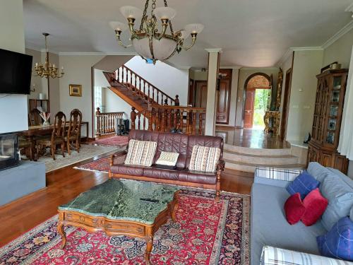 a living room with a couch and a table at Casa Chalet, Villa Elisa in Gijón