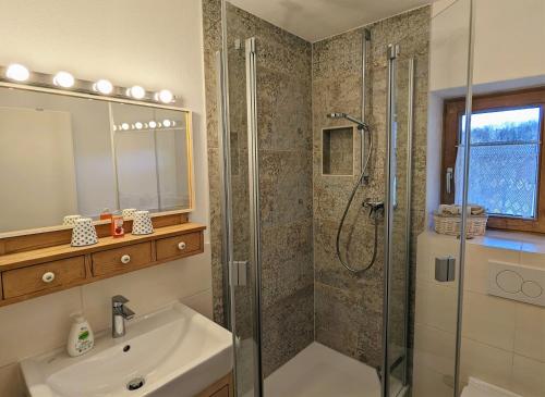 a bathroom with a shower and a sink at Lieblingsort in Unterwössen