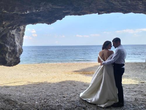 a bride and groom standing on the beach at Villa Paradise (Amalfi Coast - Luxury Home - Beach) in Vietri sul Mare