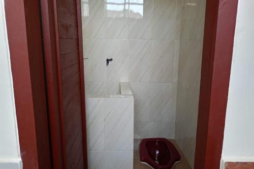 a bathroom with a toilet in a shower at SPOT ON 92743 Kost Elisabeth Syariah in Ngadipuro