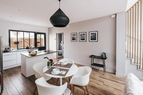 a kitchen and dining room with a table and chairs at 64 Sur Le Mail in La Rochelle