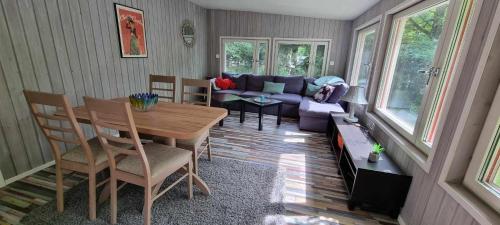 a living room with a table and a couch at Lygnareds Camping in Alingsås