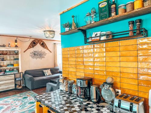 a living room with a coffee maker on a table at Auberge Mandala in Saint Mathieu Du Parc