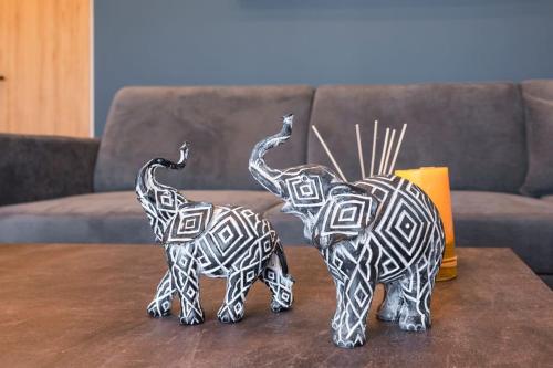 two metal elephants sitting on a coffee table at Aspect Luxury Apartment I in Galangádhos