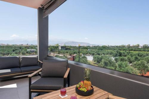 a balcony with a table and chairs and a view at Aspect Luxury Apartments with Pool in Galangádhos