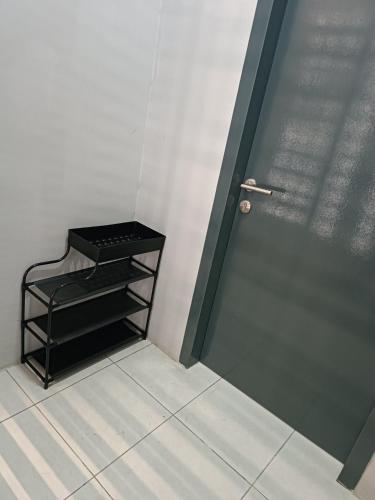 a door in a room with a shelf next to it at Aisy Homestay Putrajaya Cyberjaya KLIA in Kampung Dengkil