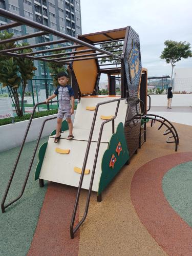 a young boy is on a merry go round on a playground at Aisy Homestay Putrajaya Cyberjaya KLIA in Kampung Dengkil