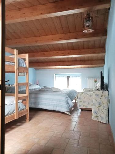 a bedroom with two bunk beds and a couch at Il Borgo della Zittola in Montenero Val Cocchiara