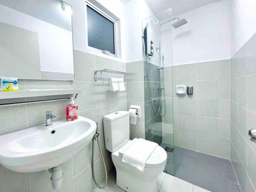a bathroom with a sink and a toilet and a shower at Alanis Studio Suite {shortstay} in Sepang