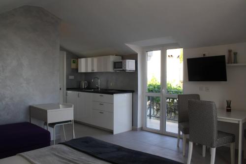 a kitchen and dining room with a table and chairs at Apartments Grković Trsteno Adventure Experience Accommodation 1 in Dubrovnik