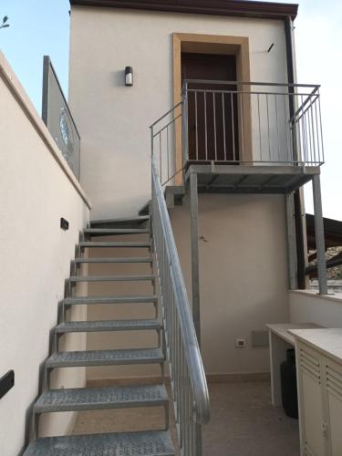 a staircase leading up to a building with a door at Appartamenti Petali Di Rosa in Custonaci