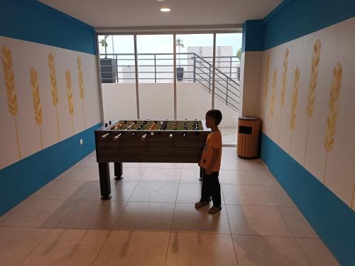 a little boy standing in front of a pool table at Aisy Homestay Putrajaya Cyberjaya KLIA in Kampung Dengkil