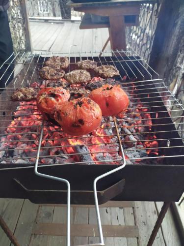 a grill with meat and other foods on it at Ali Ancient House 555 in Sheki
