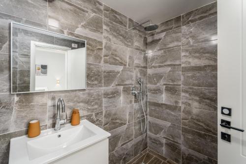 a bathroom with a sink and a shower at New Luxury 3 BR - Next the Orient Hotel in Jerusalem