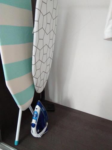 a pair of shoes sitting on a floor next to a bed at Apartament City Center JAPAN - no smoking, free bottled water, coffea and tea in Koszalin