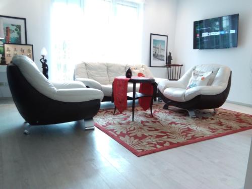 a living room with two chairs and a table at Apartament City Center JAPAN - no smoking, free bottled water, coffea and tea in Koszalin
