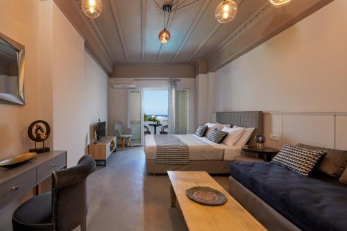 a living room with a couch and a table at Blue Sea Hotel in Kamari