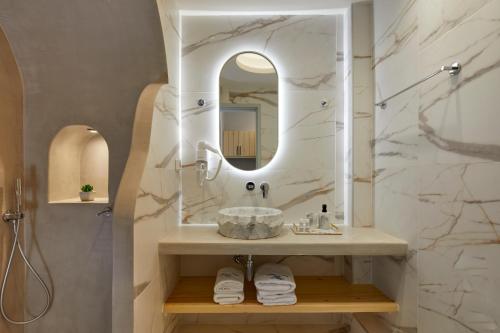 a bathroom with a sink and a mirror at Blue Sea Hotel in Kamari