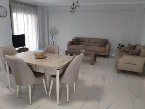 a living room with a wooden table and chairs at Family house in Ofrínion