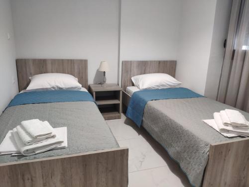 two beds sitting next to each other in a bedroom at Family house in Ofrínion