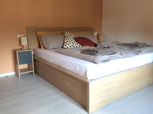 a bedroom with a bed with a wooden frame at Al Borgo Appartamento in Venzone