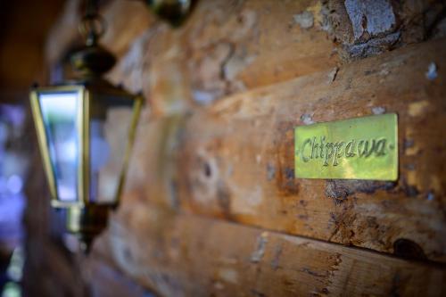a sign on a wooden wall with a light on it at Villa Vanille in Boisseron