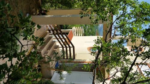 a staircase leading up to a house with trees at Apartments Kristina in Klenovica