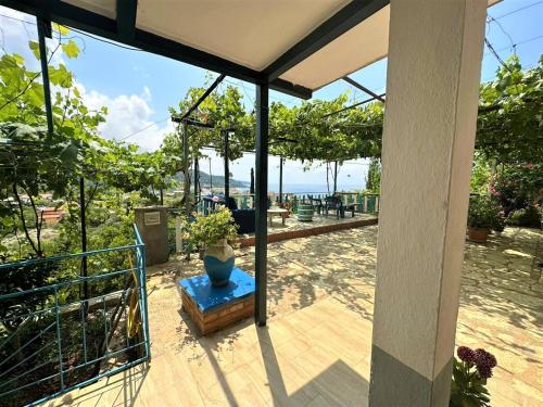 a patio with a view of the ocean from a house at Boungainvillea in Himare