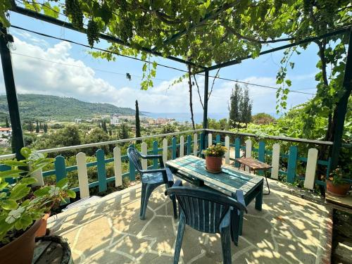 a table and chairs on a balcony with a view at Boungainvillea in Himare