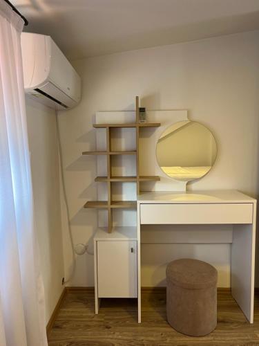 a bathroom with a dressing table and a mirror at Zani Boutique Hotel in Prizren